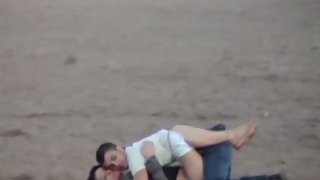 Youthfull lovers making out on the beach voyeur sex tape long lens camera